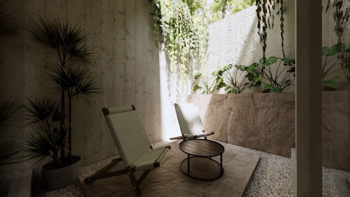 Private courtyard with sling chairs on gravel, a stone bench and trailing planting down a rendered wall