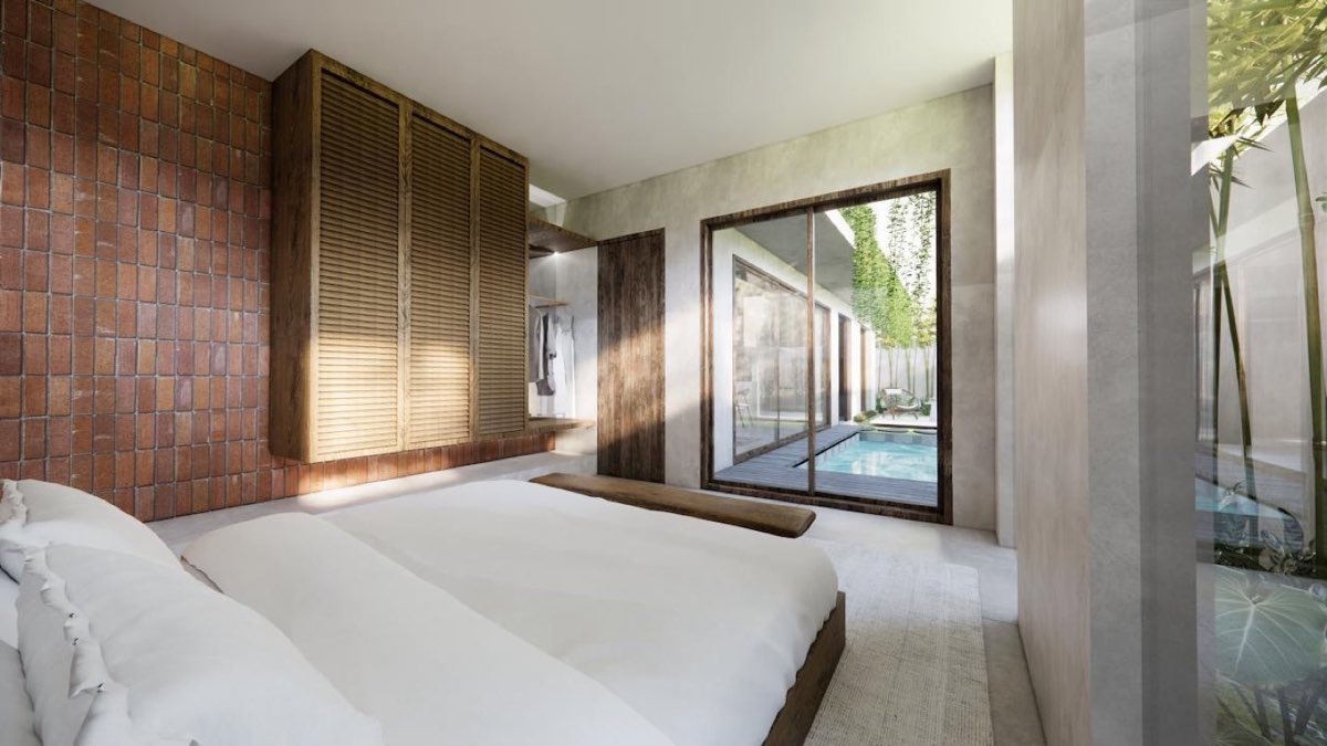Bedroom looking past a louvred timber wardrobe through glazing to the pool outside