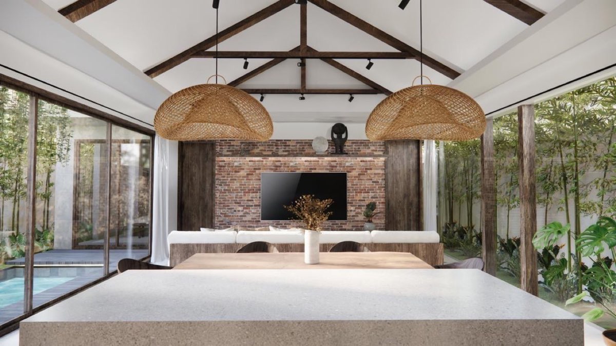 Living area under the timber truss looking out to the pool, with a brick media wall and rattan pendants
